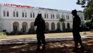 Security personnel stand guard outside the President's house premises after protestors vacated it following the news of President Gotabaya Rajapaksa leaving the country, amid the country's economic crisis, in Colombo, Sri Lanka, July 14, 2022. (REUTERS/Adnan Abidi)