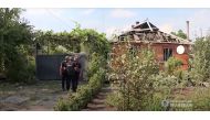 Police officers gather in front of a house damaged after a missile strike, amid Russia's invasion of Ukraine, in Pokrovsk, Donetsk region, Ukraine in this screen grab taken from a handout video released July 16, 2022. State National Police of Ukraine/Handout via REUTERS