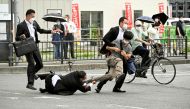 The alleged assassin of former Japanese Prime Minister Shinzo Abe is tackled by police officers in Nara, western Japan, on July 8, 2022. (Reuters)


