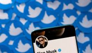 File Photo: Elon Musk's Twitter profile is seen on a smartphone placed on printed Twitter logos in this picture illustration taken April 28, 2022. (REUTERS/Dado Ruvic)