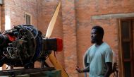 Ghanaian artist Ibrahim Mahama, 35, inspects an aircraft propeller engine at his studio facility in Tamale, Ghana, July 15, 2022. REUTERS/Francis Kokoroko