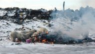 Polar bears scavenge for food at a dump in Churchill, Canada, in this handout image dated circa 2003. In 2005, the community permanently closed its dump and now stores garbage in a secure facility. Dan Guravich/Polar Bears International/Handout via REUTERS 