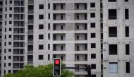 A traffic light is seen near a construction site of residential buildings in Shanghai, China July 20, 2022. REUTERS/Aly Song