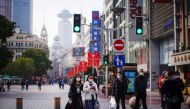 People wearing face masks walk at a main shopping area, following the coronavirus disease (COVID-19) outbreak in Shanghai, China January 27, 2021. REUTERS/Aly Song/File Photo

