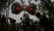 Ukrainian service members fire a shell from a M777 Howitzer at a front line, as Russia's attack on Ukraine continues, in Kharkiv Region, Ukraine, July 21, 2022. (REUTERS/Gleb Garanich)

