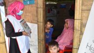 A volunteer talks to woman at a health centre.