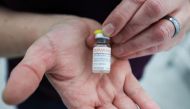 A healthcare worker shows a bottle of the monkeypox vaccine at a clinic run by CIUSSS public health authorities in Montreal, Quebec, Canada, June 6, 2022. REUTERS/Christinne Muschi

