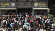 People queue to buy bread outside a bakery in Beirut, Lebanon, on July 27, 2022. (REUTERS/Mohamed Azakir)