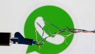 Broken Ethernet cable is seen in front of WhatsApp logo in this illustration taken March 11, 2022. (REUTERS/Dado Ruvic)