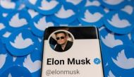 Elon Musk's Twitter profile is seen on a smartphone placed on printed Twitter logos in this picture illustration. REUTERS/Dado Ruvic/Illustration