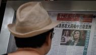 A man reads the Global Times newspaper that features a front page article about US House of Representatives Speaker Nancy Pelosi's Asia tour at a street display wall in Beijing, China, August 1, 2022. The front page headline reads: 