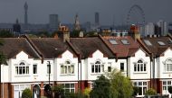 A person jogs past a row of residential housing in south London, Britain, August 6, 2021. REUTERS/Henry Nicholls

L