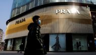 File Photo: A man walks past a store of Italian luxury brand Prada on a shopping street in Beijing, China, January 20, 2021. (REUTERS/Tingshu Wang)
