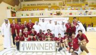 Qatar players and officials celebrate with the trophy 
