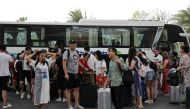 People get off a coach at an entrance of Atlantis Sanya resort in Sanya, Hainan province, China November 25, 2020. Picture taken November 25, 2020. REUTERS/Tingshu Wang/File Photo