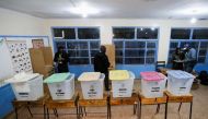 Workers from the Independent Electoral and Boundaries Commission (IEBC) prepare a polling centre ahead of the opening of the general election in Nairobi, Kenya August 9, 2022. REUTERS/Thomas Mukoya


