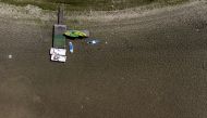 Kayaks, pedal boats and paddle boards are seen on the dried bed of the drought-affected Doubs River on the border with France in Les Brenets, Switzerland, August 8, 2022. REUTERS/Denis Balibouse