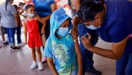A child receives a dose of the Pfizer-BioNTech coronavirus disease (Covid-19) pediatric vaccine during a mass vaccination program for children ages 6 to 7 in Ciudad Juarez, Mexico, August 9, 2022. (REUTERS/Jose Luis Gonzalez)