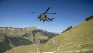 A Swiss Air Force Super Puma helicopter delivers water for cows in the Tissiniva mountain pasture due to an ongoing drought in Charmey, Switzerland, August 10, 2022. REUTERS/Denis Balibouse


