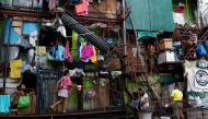 Residents of a small apartment building do house chores outside their units, amid the lockdown to contain the coronavirus disease (COVID-19), in a slum area in Tondo, Manila, Philippines, May 4, 2020. REUTERS/Eloisa Lopez/File Photo/File Photo
