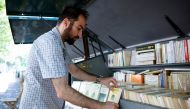 New Parisian bouquiniste, traditional street bookseller, Rachid Bouanou puts up stalls along the banks of the River Seine in Paris, France, August 18, 2022. REUTERS/Sarah Meyssonnier