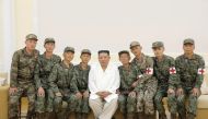 North Korea's leader Kim Jong-un poses for a photo with Korean People's Army medics during a meeting to recognise their contributions in fighting the coronavirus disease (COVID-19) pandemic in Pyongyang, North Korea, August 18, 2022 in this photo released by North Korea's Korean Central News Agency via REUTERS.