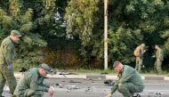 Investigators work at the site of a suspected car bomb attack that killed Darya Dugina in the Moscow region, Russia August 21, 2022. Investigative Committee of Russia/Handout via Reuters
