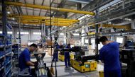FILE PHOTO:Employees work on the production line of vehicle components during a government-organised media tour to a factory of German engineering group Voith, following the coronavirus disease (COVID-19) outbreak, in Shanghai, China July 21, 2022. REUTERS/Aly Song

