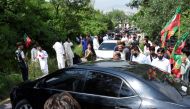 Supporters of former Pakistan's Prime Minister Imran Khan block a road with a car, as they gather to prevent his arrest on anti-terrorism charges, in Islamabad Pakistan, August 22, 2022. (REUTERS/Waseem Khan)