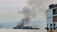 A general view shows smoke erupting from M/V Asia Philippines Starlite shipping vessel at an anchorage area in Batangas, Philippines, August 26, 2022. Philippine Coast Guard/Handout via REUTERS