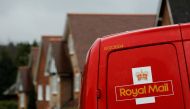 File Photo: A Royal Mail postal van is parked outside homes in Maybury near Woking in southern England, March 25, 2014. (REUTERS/Luke MacGregor)