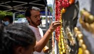 Venezuelan artist Oscar Olivares uses bottle caps to create colorful eco-mural to raise awareness for recycling, in Caracas, Venezuela August 19, 2022. Reuters/Gaby Oraa