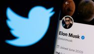 Elon Musk's twitter account is seen on a smartphone in front of the Twitter logo in this photo illustration taken on April 15, 2022. REUTERS/Dado Ruvic/Illustration/File Photo