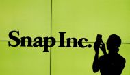 A woman stands in front of the logo of Snap Inc. on the floor of the New York Stock Exchange (NYSE) in New York City, on March 2, 2017. File Photo / Reuters