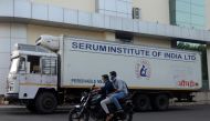 Men ride on a motorbike past a supply truck of India's Serum Institute, the world's largest maker of vaccines, which is working on a vaccine against the coronavirus disease (COVID-19) in Pune, India, on May 18, 2020. File Photo / Reuters

