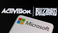 Microsoft logo is seen on a smartphone placed on displayed Activision Blizzard logo in this illustration taken on January 18, 2022. REUTERS/Dado Ruvic/Illustration/File Photo