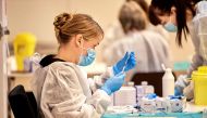 Pfizer-BioNTech COVID-19 vaccine is prepared for Plejecenter Faelledgaarden nursing home residents to get their second shot in Copenhagen, Denmark January 23, 2021. Ritzau Scanpix/Nils Meilvang via REUTERS/Files


