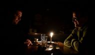 People have coffee at a bar during a power cut in Pristina, Kosovo, December 27, 2021. Picture taken December 27, 2021. REUTERS/Laura Hasani/File Photo