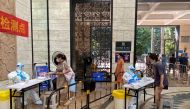 Medical workers in protective suits collect swabs from residents at a residential compound in Nanshan district, following a coronavirus disease (COVID-19) outbreak in Shenzhen, Guangdong province, China, on September 3, 2022. REUTERS/David Kirton