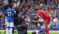 Everton's Amadou Onana receives medical attention as Liverpool's Virgil van Dijk looks on REUTERS/Phil Noble 