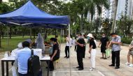 People wearing face masks line up to receive nucleic acid test near a residential area, following the outbreak of the coronavirus disease, in Shenzhen, Guangdong province, China on June 24, 2020.  File Photo / Reuters