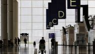 A traveller walks in the departure hall at the Hong Kong International Airport amid the coronavirus disease (COVID-19) pandemic in Hong Kong, China, March 21, 2022. REUTERS/Tyrone Siu/File Photo

