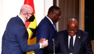 European Council President Charles Michel shakes hands with Ghana's President Nana Afuko Addo, as Senegal's President Macky Sall walks past, after a joint press conference with French President Emmanuel Macron on France's engagement in the Sahel region, at the Elysee Palace, in Paris, on February 17, 2022.  EPA-EFE/IAN LANGSDON/Pool via REUTERS