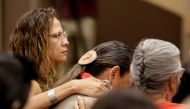 Community members listen to comments by Mark Arcand, brother of stabbing victim Bonnie Burns who was killed at James Smith Cree Nation, at a news conference in Saskatoon, Saskatchewan, Canada, September 7, 2022. Reuters/Valerie Zink