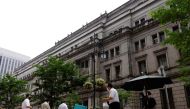 People buy their lunches from street vendors in front of the headquarters of Bank of Japan in Tokyo, Japan, June 17, 2022. REUTERS/Kim Kyung-Hoon/File Photo

