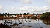 Residents walk on a makeshift bridge after the main one collapsed and washed away by the flood water near the Lac Rose also known as Lake Retba in Niaga Village near Dakar, Senegal, September 6, 2022. REUTERS/Zohra Bensemra