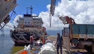 Labourers unload rice bags from a supply truck at India's main rice port at Kakinada Anchorage in the southern state of Andhra Pradesh, India, on September 2, 2021. (REUTERS/Rajendra Jadhav)