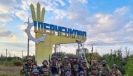 Ukrainian service members pose for in the recently liberated settlement of Shevchenkove, Ukraine amid Russia's attack on the country, in this handout picture released on September 10, 2022. Press service of the Territorial Defence of the Ukrainian Armed Forces/Handout via REUTERS