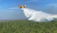 An aerial view shows a Canadair aircraft dropping water over the forest near Saumos in the Gironde region of southwestern France, in this handout picture released on September 14, 2022. SDIS 33/Handout via REUTERS