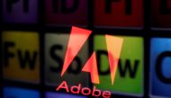 An Adobe logo and Adobe products are seen reflected on a monitor display and an iPad screen, in this picture illustration July 8, 2013. File Photo / Reuters